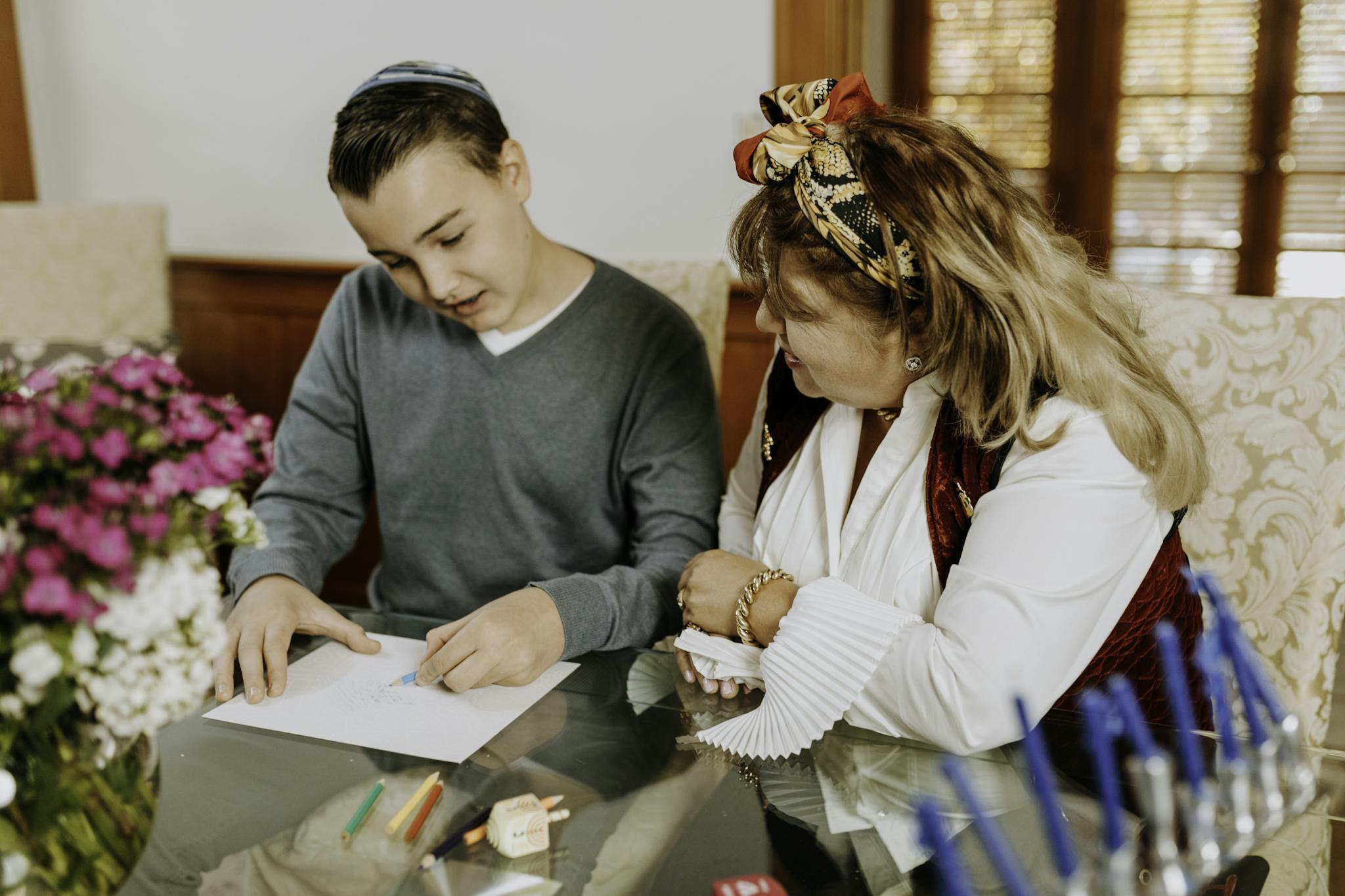 Photo Of Mother Looking At Her Son's Work